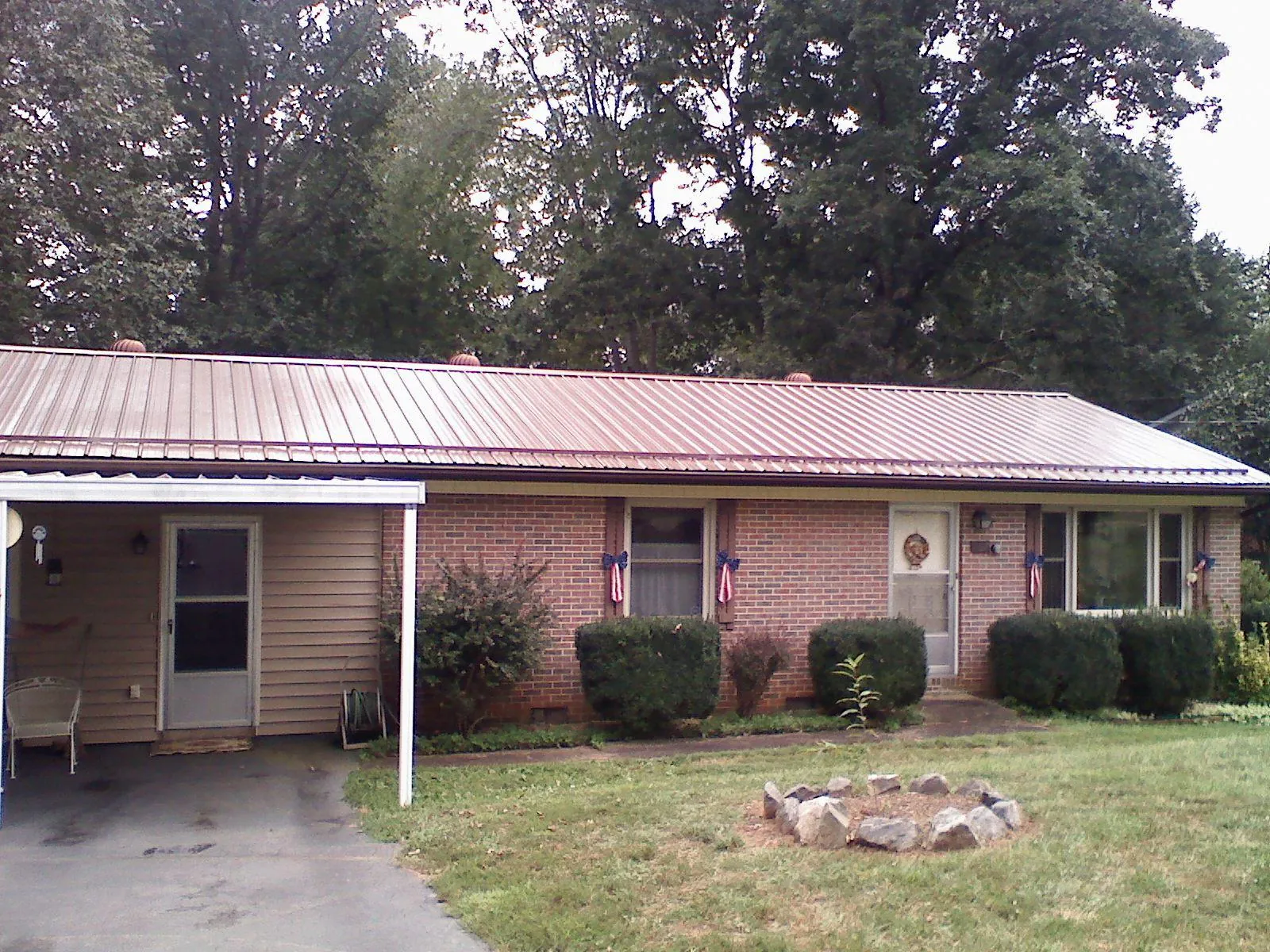 Bronze metal roof and carport on a brick ranch home — Roof Repair work by our crew in Folsom
